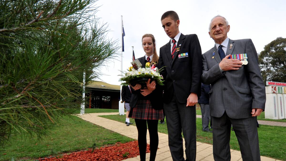School captains Genevieve Erskine and Hugh Ebbs lay a wreath with Vic Bradley. PICTURE: JEREMY BANNISTER