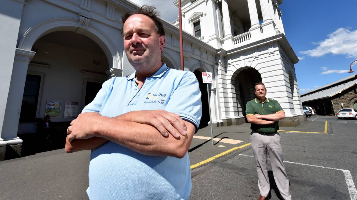 Chris Andrew, front, has been unemployed for two weeks after failing to renew his taxi licence accreditation. He is pictured with Ballarat Taxi Co-operative chairman Stephen Armstong. PICTURE: JEREMY BANNISTER