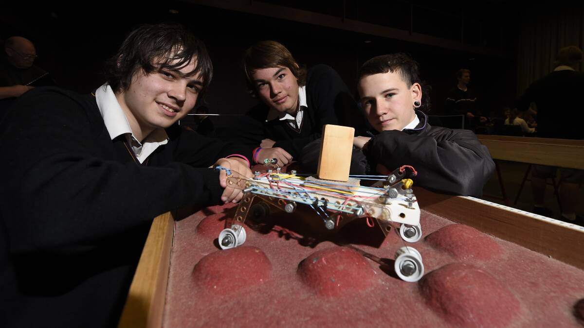 Sam Patrono-Minel, Kyle Badari and Angus Smith work on their project, a vehicle for Mars. PICTURE: JUSTIN WHITELOCK