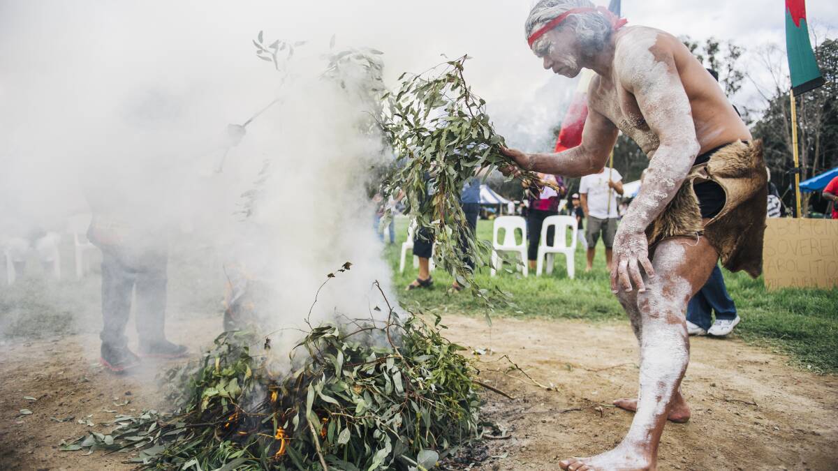 Members of Canberra’s Aboriginal community mark “Invasion Day” with a smoke ceremony.