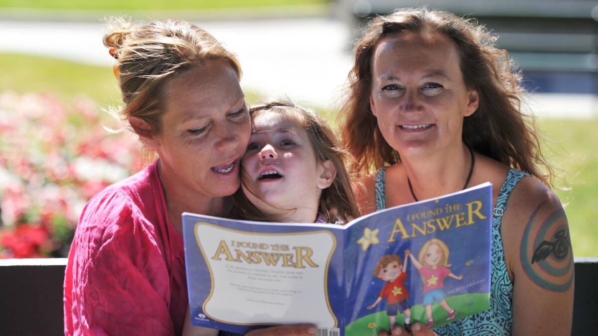 fun read: Tammy Bennett, with daughter Jade Bailey, and Nerissa Kennedy read their self-published book. PICTURE: JEREMY BANNISTER