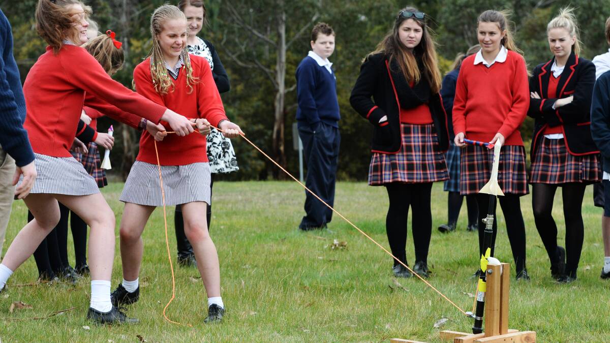 Year nine students Matilda White 15, and Emma Cornwill, 15, fire their rocket as part of the FedUni Science and Engineering Investigation Awards