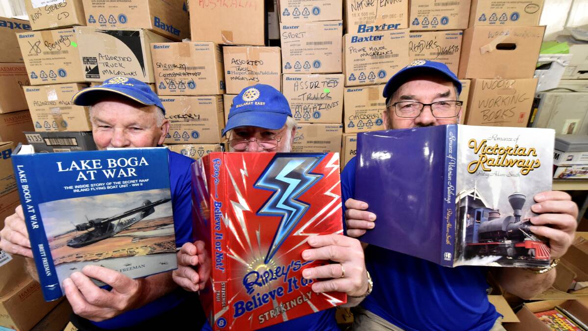 Rotarians Rob Petrie, Jeff Miller and John Olsen get stuck into some rare and collectable books. PICTURE: JEREMY BANNISTER