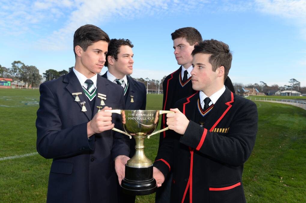 St Patrick's College football captain Liam Duggan and Ballarat Clarendon College football captain Matt Davidson, flanked by their deputies Rylry Stuhldrier (SPC) and Keegan Mason (BCC) with the coveted O'Malley Cup they will battle to win on Wednesday. Photo Kate Healy