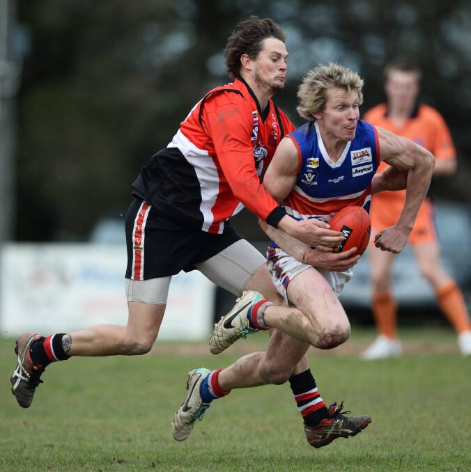 Daylesford's Trent Nesbitt is tackled by Carngham-Linton's Tim Clarke. Picture - Adam Trafford.