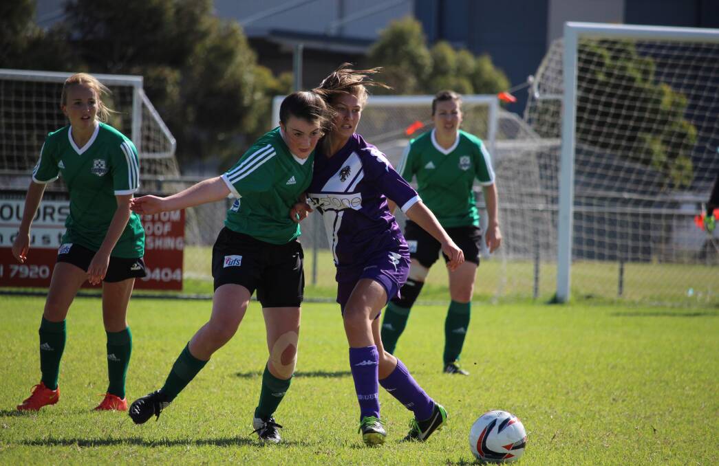 Erin Plucke, left, looks on as fellow Ballarat Eureka Striker Lily McLean fights for the ball in Sunday’s big win over Keilor Park. Picture - Bernie Curtain.