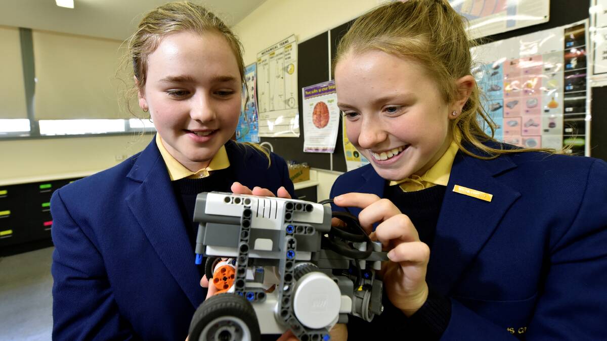Damascus College students Bronnie Hughes, left, and Ellie Carroll with the robot they built in a Robogals workshop at their school.