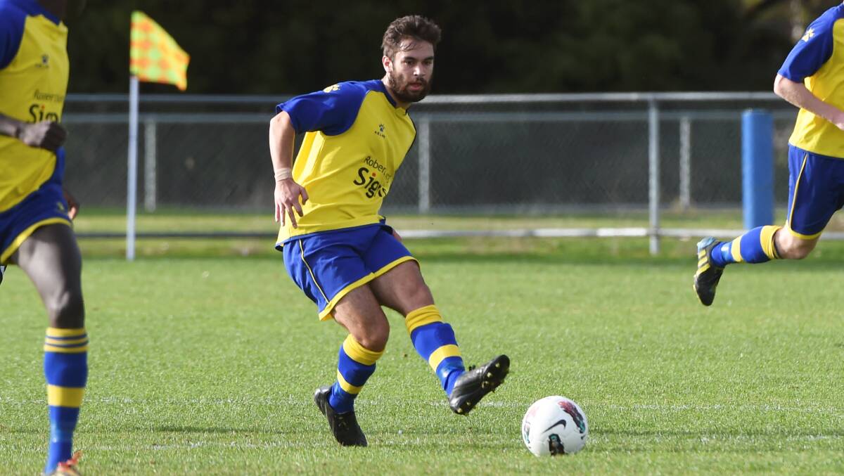Sebastopol Viking Kyran Taylor kicks the ball in his team's 2014 clash against Melbourne City. PICTURE: LACHLAN BENCE