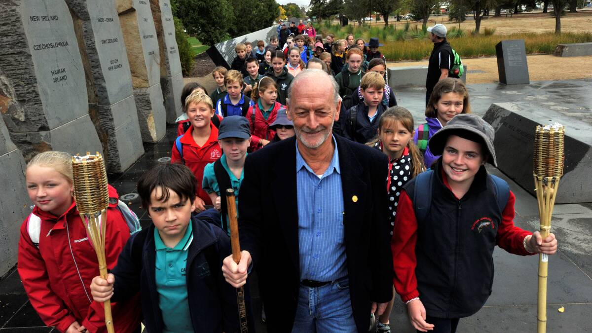 Historian and digger Garry Snowden with pupils at the ex-POW Memorial in Ballarat.