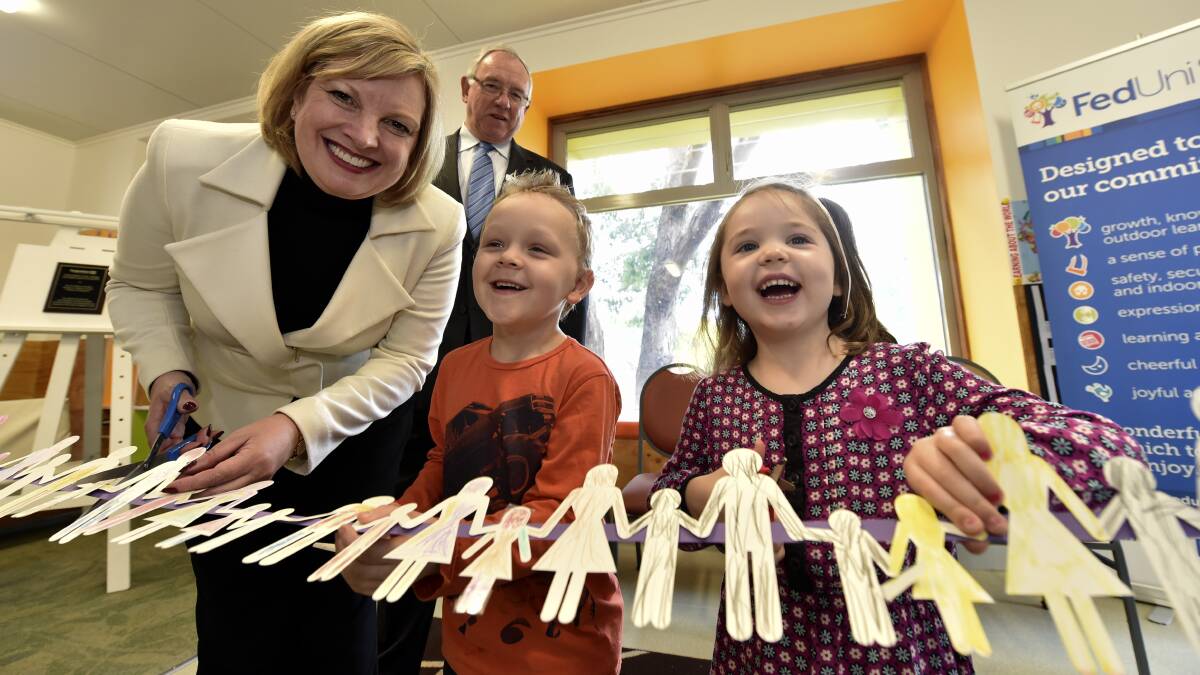 Minister for early childhood development Wendy Lovell with Riley Tierney and Matilda Ellis.