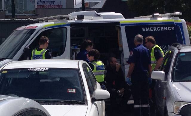 The security guard is treated by paramedics at the scene. PICTURE: David Jeans