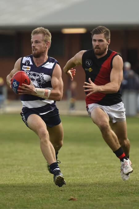 Beau Guest (Buninyong) chases down Newlyn's Nathan Skewes.