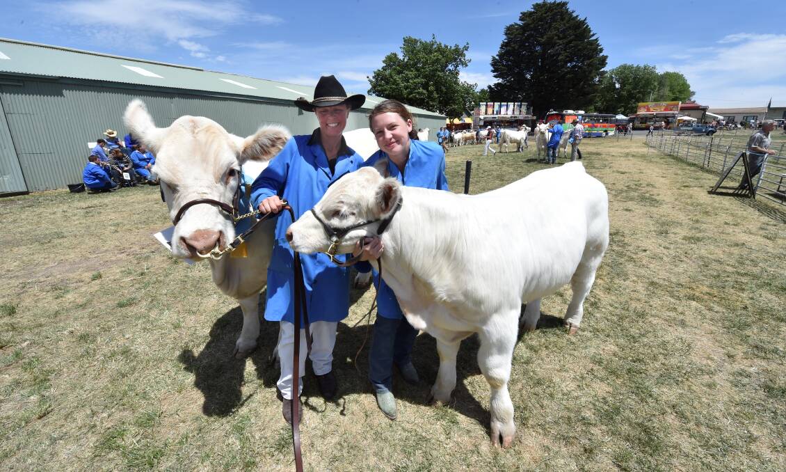 Rebecce Keley and Sarah Conroy with Cherub Rebecca, 3, and her calf who were the senior champions in the Charolais class. PICTURE: Jeremy Bannister.