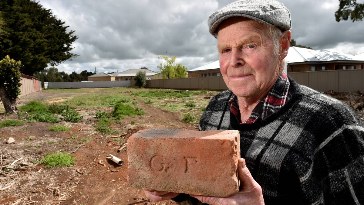 Bill Loader with a George Flewin brick made in Miners Rest and used in the construction of the stables. Picture: Jeremy Bannister.
