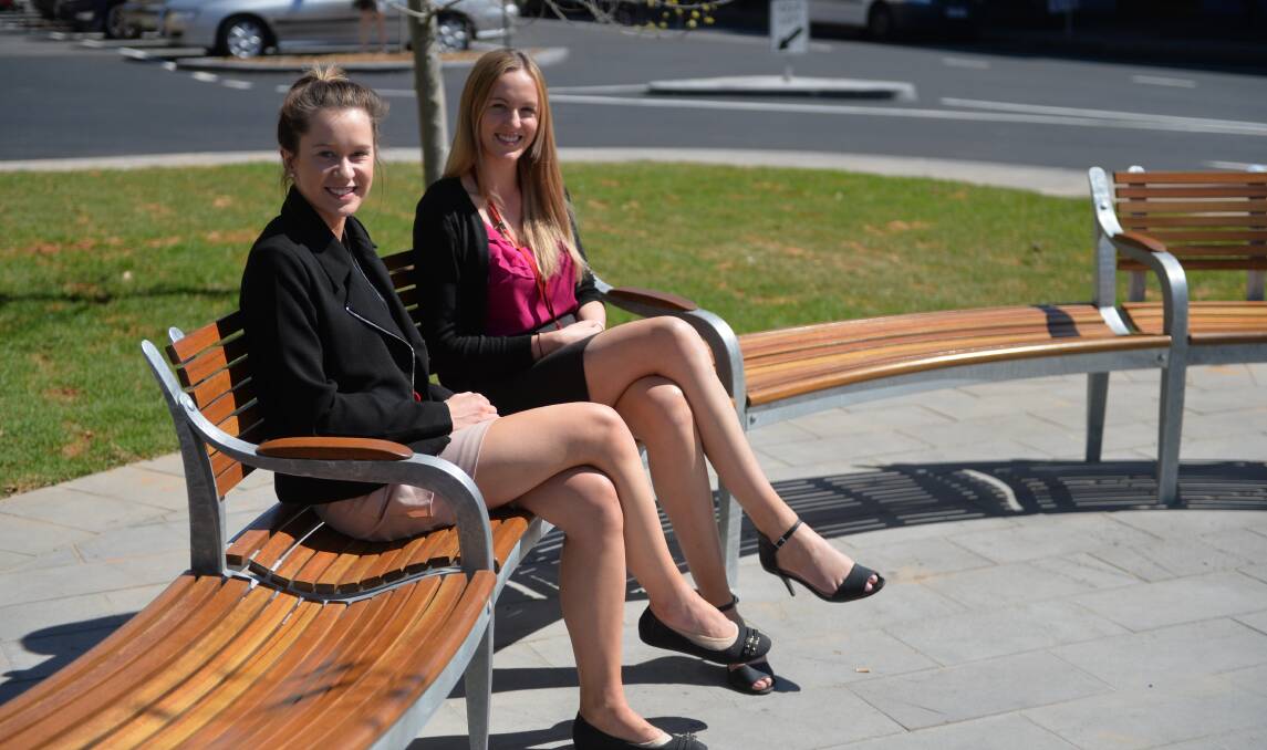 NEW SEAT: Marlow Schneider and Abby Ross try out the new bench. Picture: ANDI YU