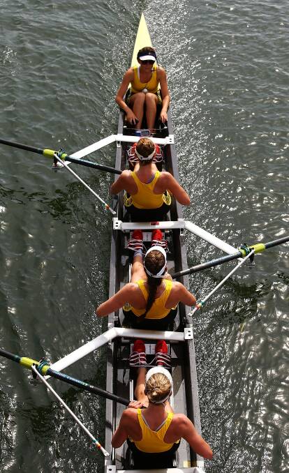 The Wetern Australian Womens crew row to the start of the Interstate womens eight race during the Rowing World Cup at the Sydney International Rowing Centre. Photo: Getty