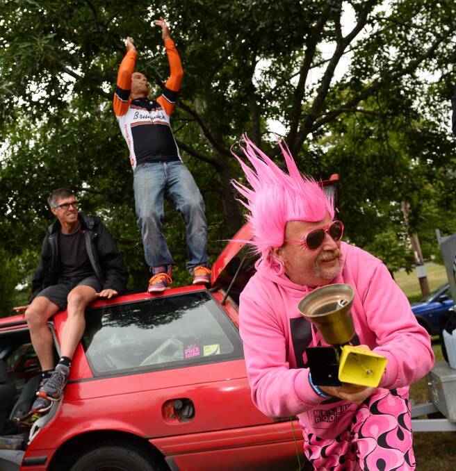The famous, the enthusiastic and the plain crazy are flocking to Buninyong to watch the race at Buninyong. David Morgan of Brunswick Cycling Club cheers on the riders with Phil Anderson and Cam McFarlane. Picture ADAM TRAFFORD