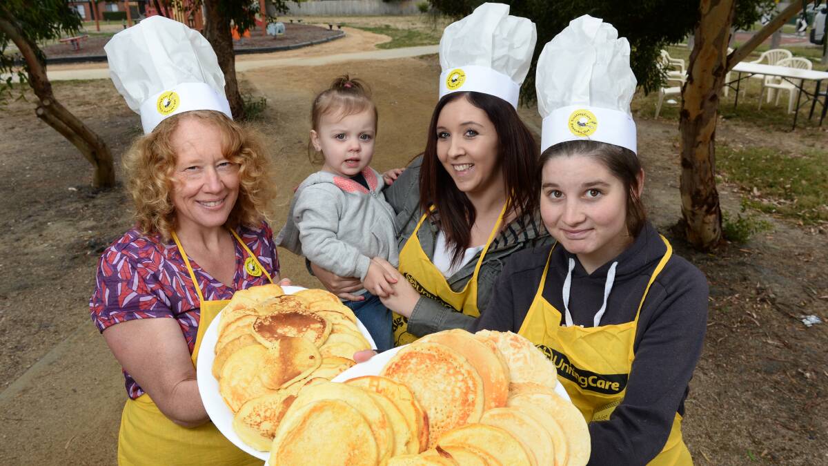 Pancake day: Link Up teacher Meredith Barclay with Chloe Bahl and baby Ruby Taylor and Ashlee Kent. 
PICTURE: ADAM TRAFFORD