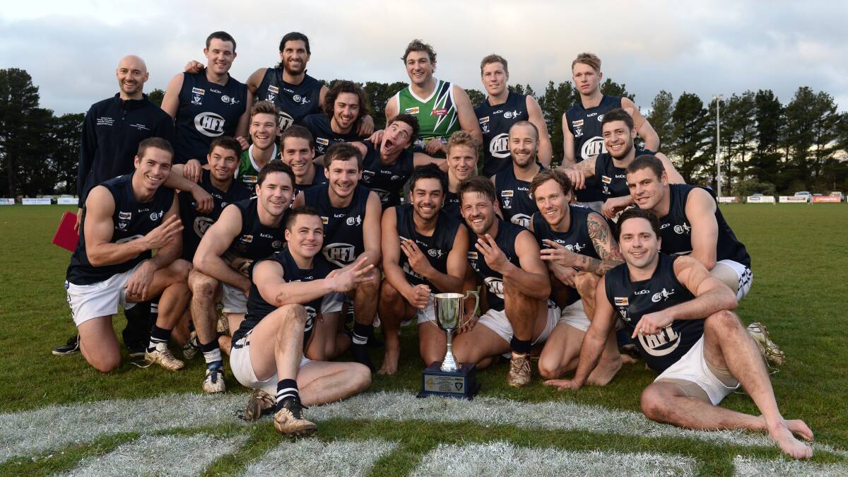 The victorious Central Highlands Football League team celebrates its third-consecutive title in the AFL Victoria Country Championships.