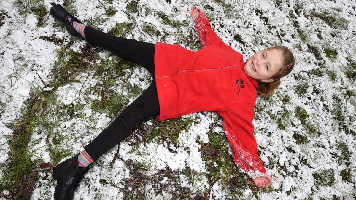 Inez Demirceviren, 7, plays in the snow at Mt Buninyong.