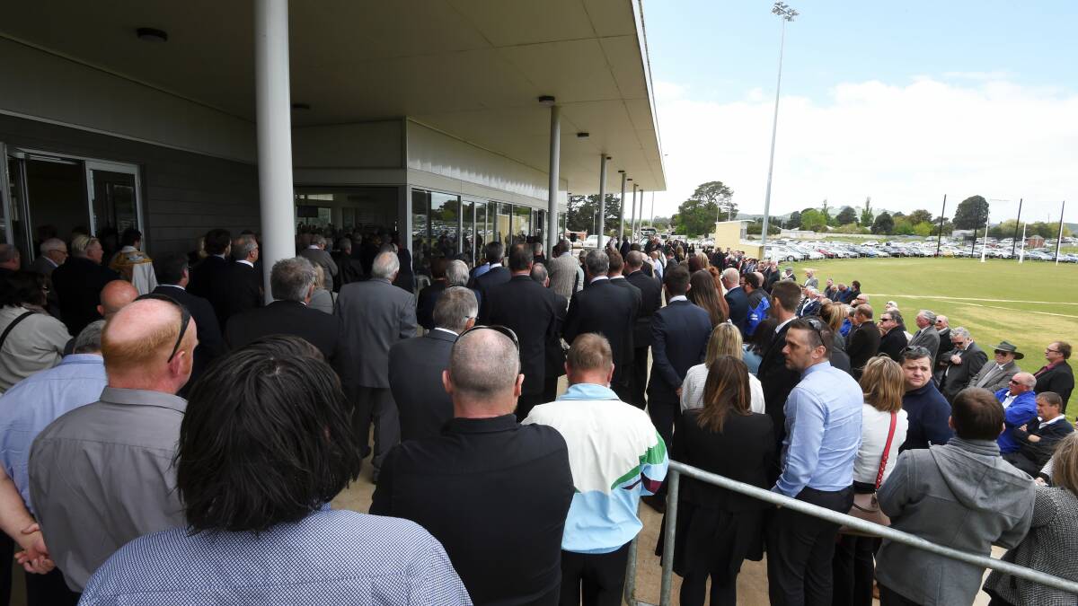 MUCH LOVED: The crowd gathered at Mrs Mitchell's funeral spilled from the pavilion at the Doug Lindsay Reserve. 