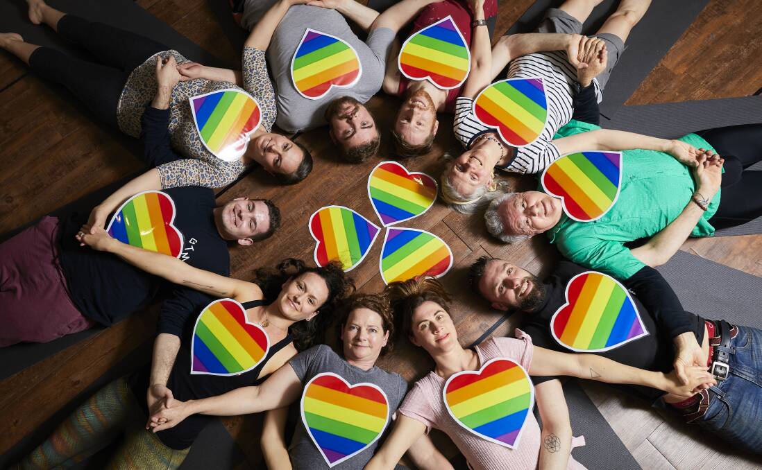 MANDALA: Instructor Lily Paskas (bottom right) and her class of budding yogis came together in a show of solidarity to support changing the marriage act. Picture: Luka Kauzlaric.