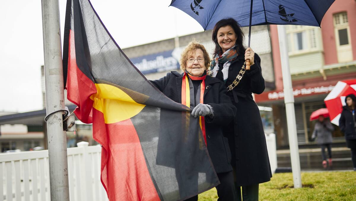 CELEBRATIONS: Ballarat mayor Samantha McIntosh and Aunty Violet McPhearson raise the Aboriginal flag as part of Naidoc week. Picture: Luka Kauzlaric