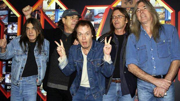 AC/DC's Malcolm Young (left) with Brian Johnson, Angus Young, Phil Rudd and Cliff Williams pose for photographers at the Apollo Hammersmith in London in 2003.  Photo: Yui Mok/AP 