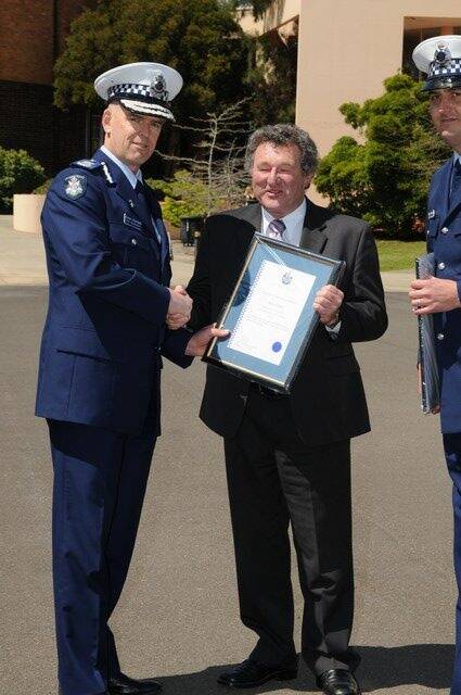 AWARD: Victoria Police Chief Commissioner Simon Overland presents Kevin Harty with his award.