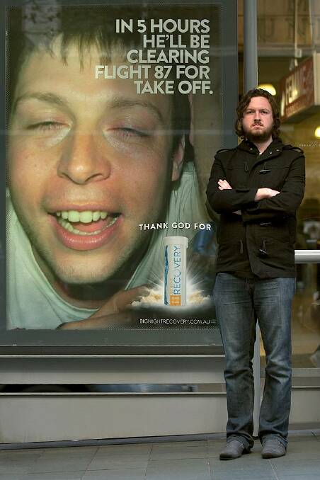 Ethical? ... Jonathan Brown with one of the offending 'recovery pill' ads on Collins Street.