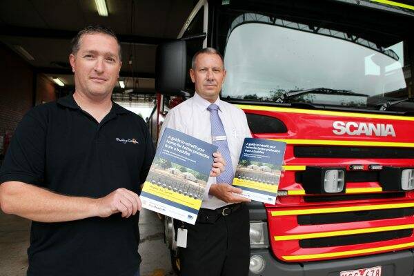 LAUNCH: Marcus Collard, left, and Michael Boatman, with the new CFA retrofit guide for firesafe buildings.