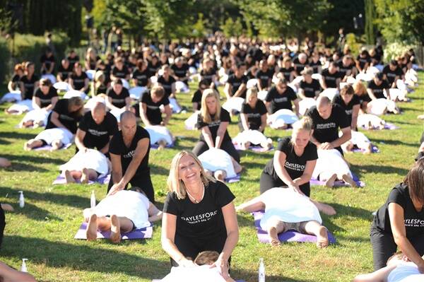 RELAXING RECORD: Masseuse Dee Terry, front, from Carrum, leads the way at yesterday's world record-breaking attempt for the largest ever simultaneous massage at Daylesford. Pictures:  Andrew Kelly