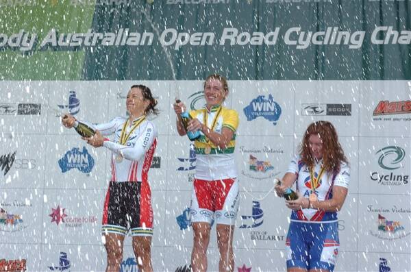 COPPING A SPRAY: Former world rowing champion  Amber Halliday  celebrates on the podium with second-placed Bridie O'Donnell, left, and Carly Light, third. Picture: Zhenshi van der Klooster