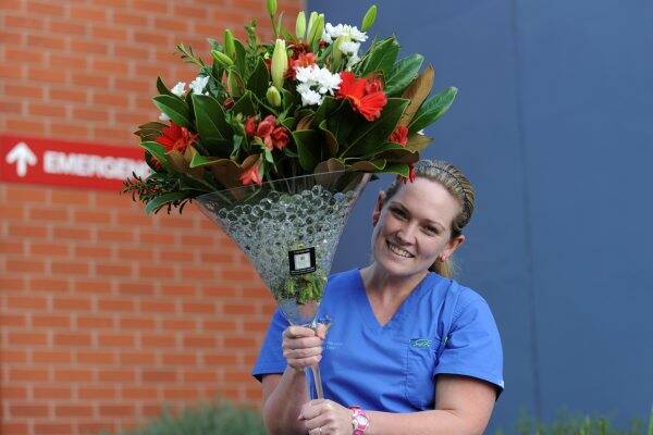 HE LOVES YOU:  Melissa White with the one-metre-tall martini glass filled with her favourite flowers she received from her husband Andrew for Valentine's Day. Picture: Jeremy Bannister