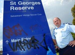 Tagged: Ballarat City councillor and Leading Senior Constable Des Hudson stands next to a graffiti-smeared sign at the Vikings Soccer Club. Picture: Kate Healy