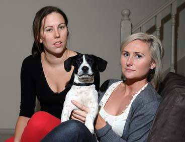 UPSET: University of Ballarat fourth year teaching students, Shona Forrest, left, and Kelscha Lumsden with their dog Hunter. The students were victims of thieves who stole their much-needed laptop com
