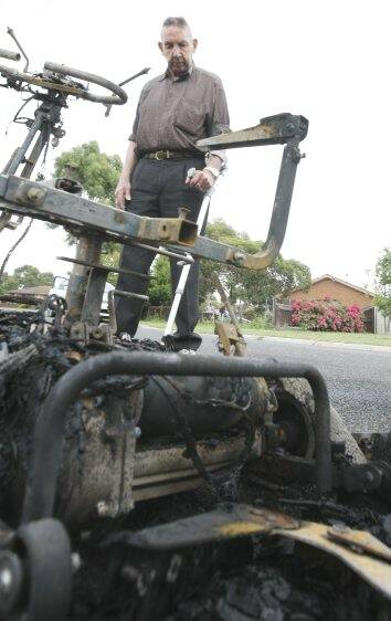 SET ALIGHT: John Odgers with his burnt scooter.