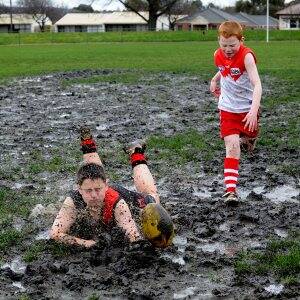 MUD BATH: Junior footballers Declan and Tadhg Waddington on the muddy Western Oval. Picture: Jeremy Bannister