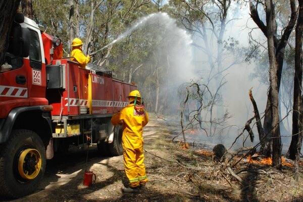 Firefighters work to contain a deliberately lit grass fire at Happy Valley, near Linton. Picture: Zhenshi van der Klooster