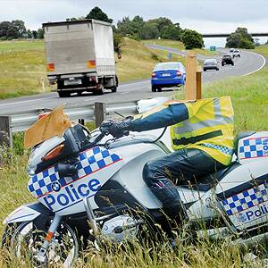 Deterrent: The cardboard cut-out motorcycle policeman that lost its head on the Western Highway at Ballan. Picture: Jeremy Bannister