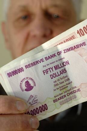 "Millionaire" John Petheram flashes  a $50 million  Zimbabwean bank note.