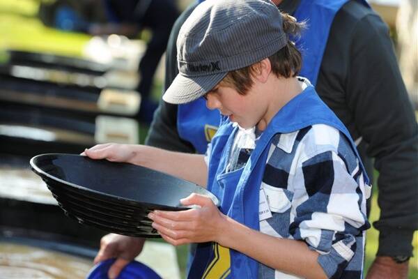 EUREKA: Ten-year-old Jeremy Gilligan competes in yesterday’s goldpanning event. Picture: Lachlan Bence