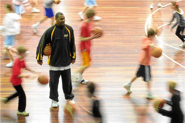 GOOD TIME: Jamal Brown put on the trainer's cap as he coached a group of kids in the basketball camp.