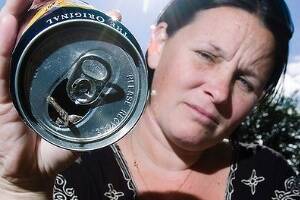 Linda Foster, of Casino, with the can of Bundaberg Rum which, she says, came with the mouse inside.