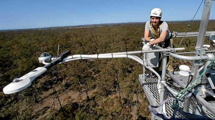 Complex: Monash University's Ian McHugh checks monitoring equipment high above the dry eucalypt forests behind Nagambie. Photo: Jason South