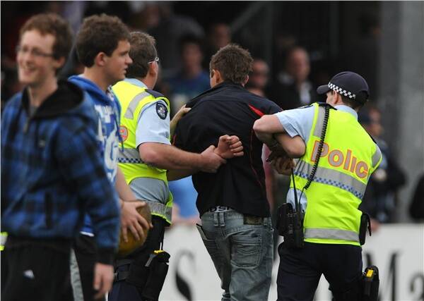 IN TROUBLE: Police lead away a spectactor during the Central Highlands Football League final at the weekend. Picture: Lachlan Bence