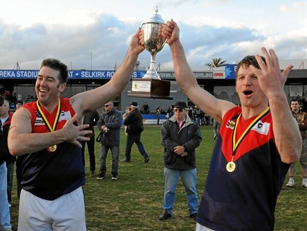 IT'S OURS: Skipton coach Tim McKay, left, and captain Kiernan Molloy celebrate their fifth grand final victory in the Lexton Plains Football League. Picture: Lachlan Bence