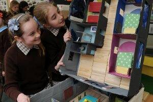 SUSTAINABLE LIVING: St Thomas More Primary School pupils Ellen Simpson and Madalyn Scholten show off their model of a sustainable house. Picture: Lachlan Bence