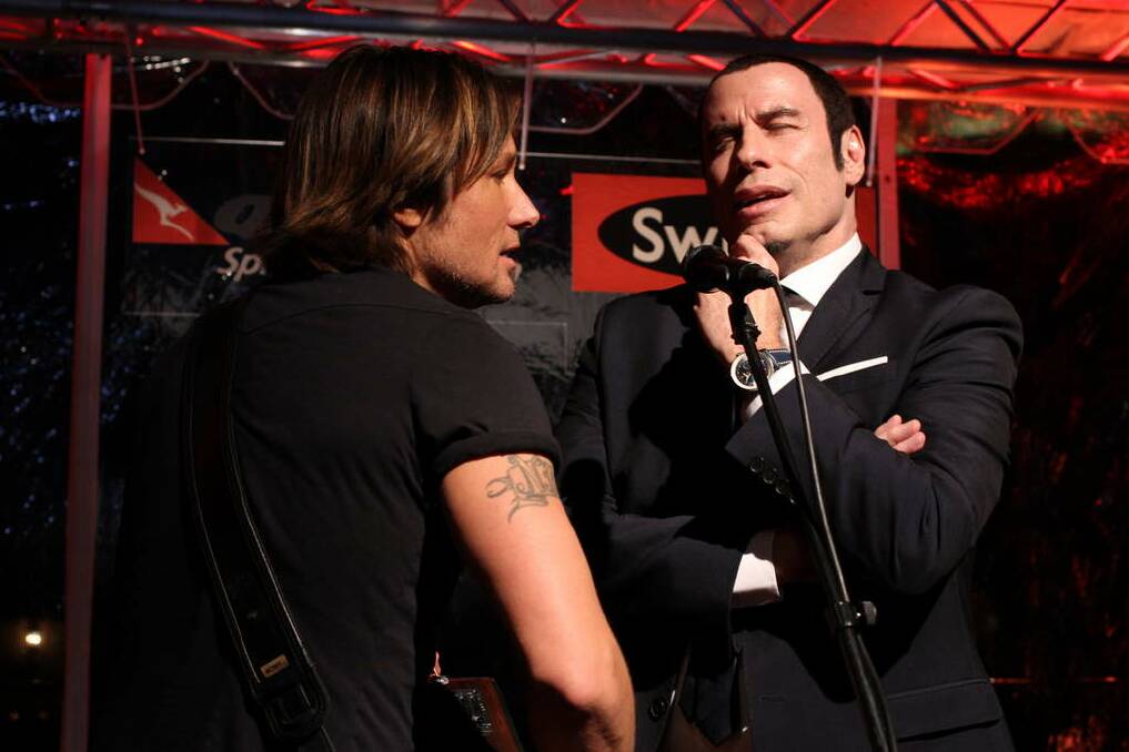Keith Urban and John Travolta belt out a tune.