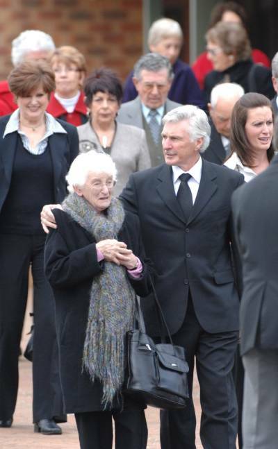 FAREWELL: Mick Malthouse comforts his mother Marie following the funeral for his father Raymond at Our Lady Help of Christians in Wendouree yesterday.